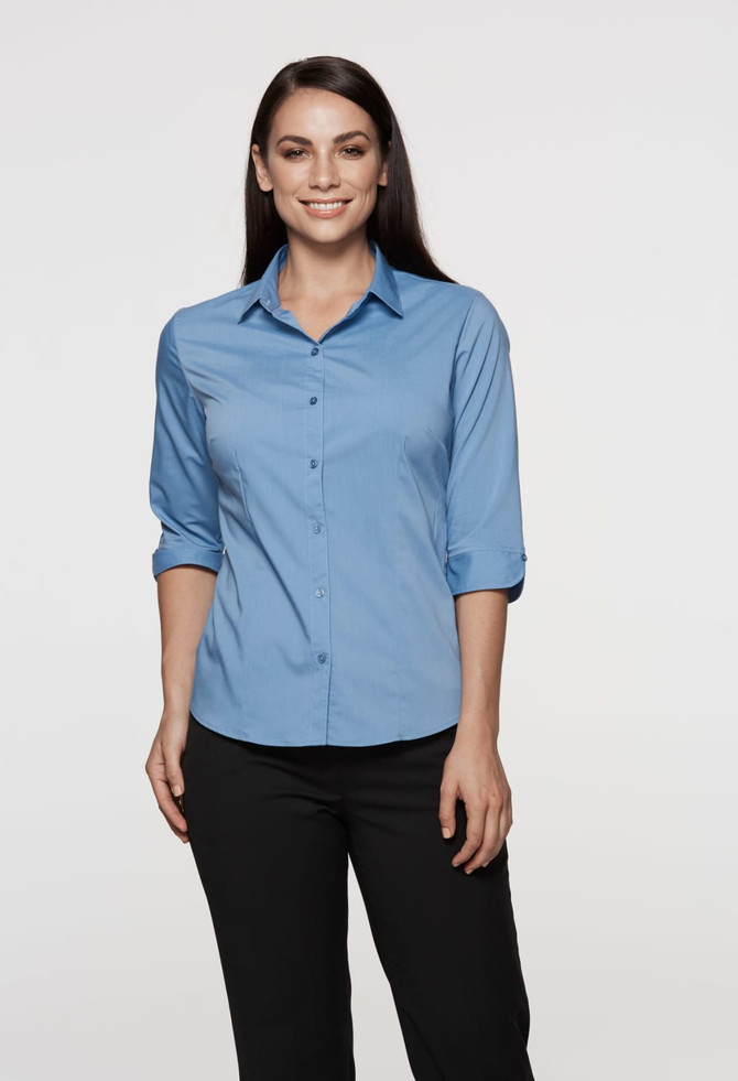 A button-up shirt in light blue with 3/4 sleeves, featuring a collar and a fitted design. It has a logo.