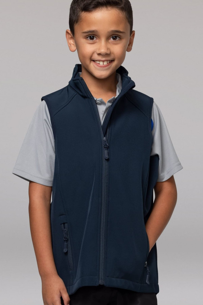 A boy smiles while wearing a navy blue kids' vest with zippered pockets and a standing collar.