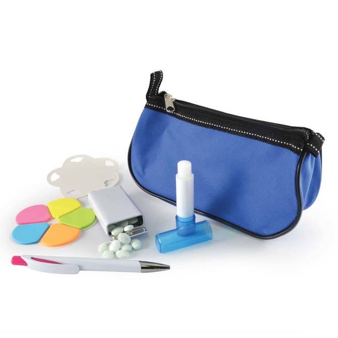A blue cosmetic pouch contains a white lip balm, a dispenser, a pen, colorful sticky notes, and small white tablets.