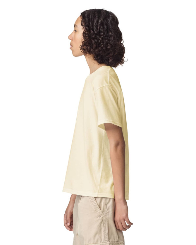 A side view of a youth t-shirt in pale yellow, featuring a relaxed fit and a logo.