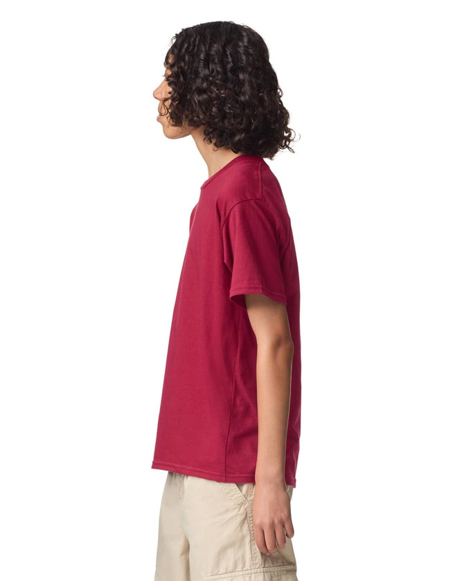 A side view of a youth T-shirt in burgundy, featuring short sleeves and a simple design with a logo.