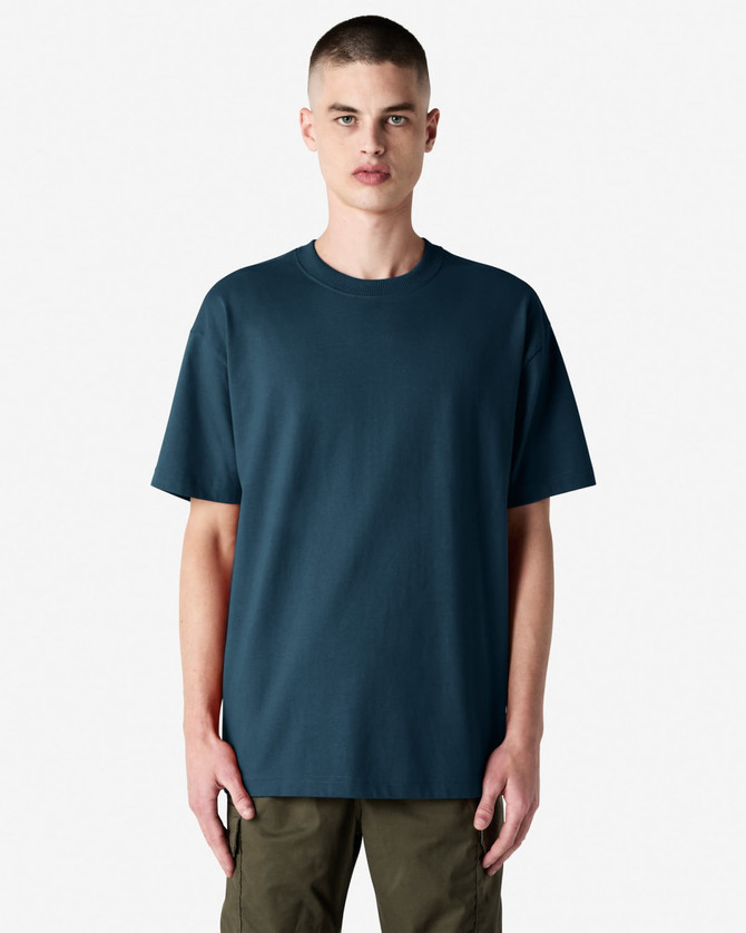A model wearing an American Apparel super heavyweight T-shirt in dark blue, paired with olive green shorts.
