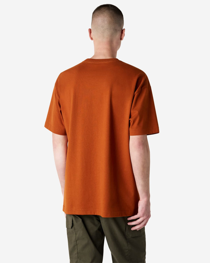 A man wearing an orange American Apparel Super Heavyweight T-Shirt, viewed from the back, with short sleeves.