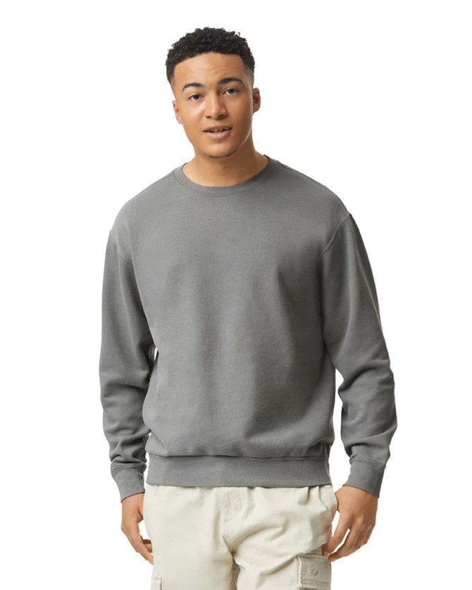 A lightweight crewneck sweatshirt in grey, worn by a model. Features ribbed cuffs and a logo.