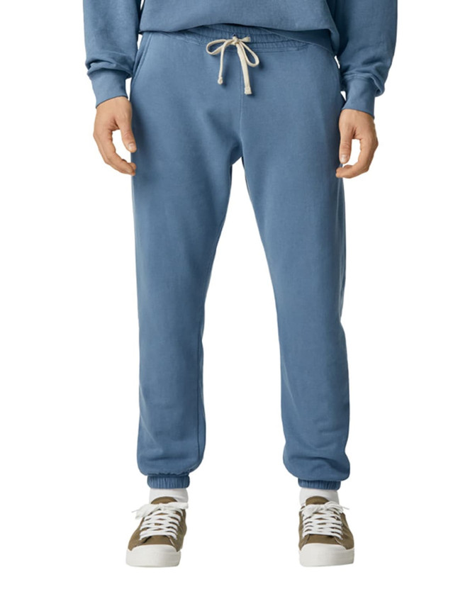 Lightweight sweatpants in a soft blue colour, featuring an elastic waist and drawstring. Paired with casual footwear.