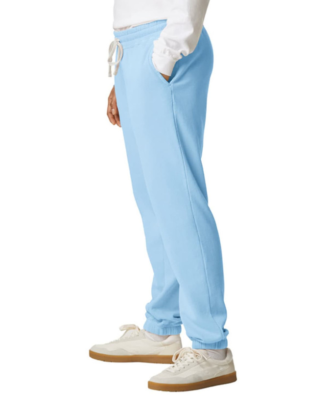 Light blue lightweight sweatpants with an elastic waistband and side pockets, paired with white sneakers.