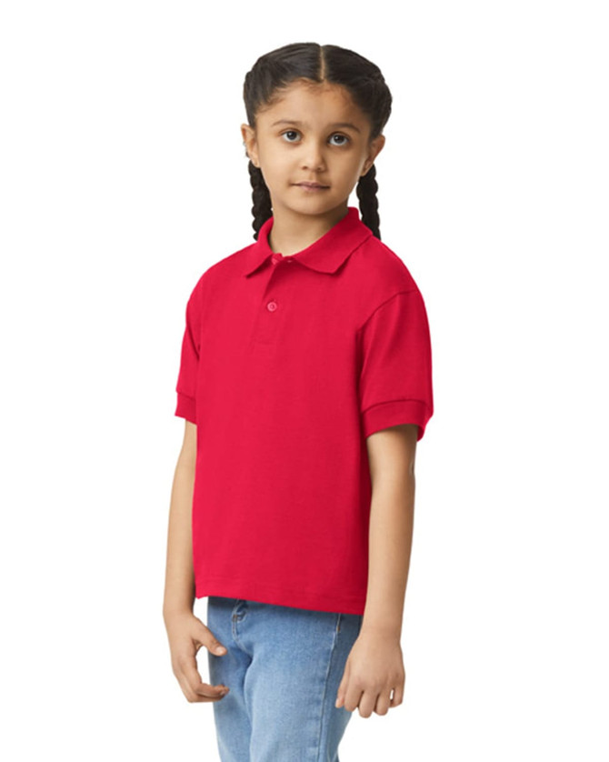 A red youth polo shirt with a collar and short sleeves, displayed on a child with braids. The shirt features a logo.
