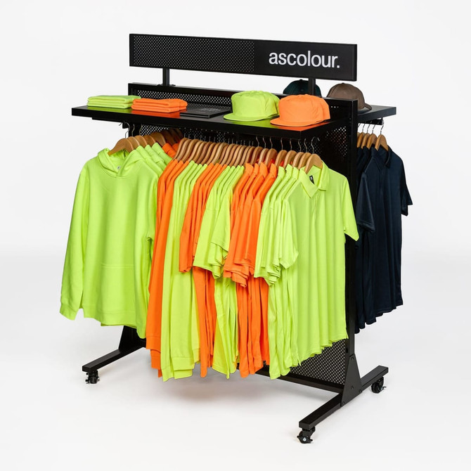 A display rack featuring orange and lime green garments, along with navy blue and brown hats. It has a branded logo.