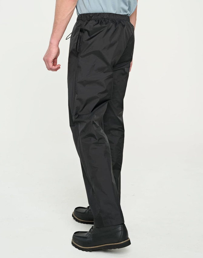 Black lightweight nylon waterproof rain pants with an elastic waist and side pockets, featuring a logo.