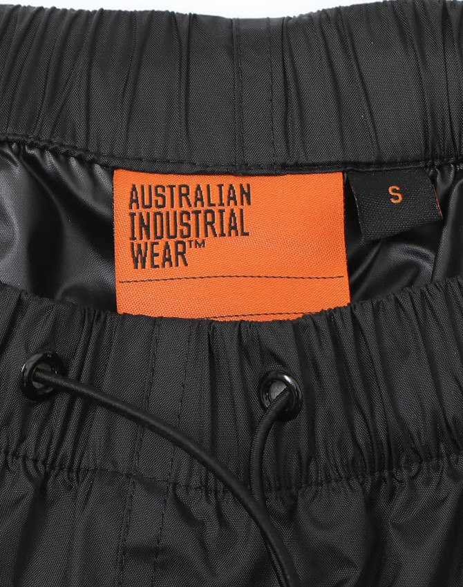 A pair of black nylon waterproof rain pants with an elastic waistband and drawstring. Features a logo inside.