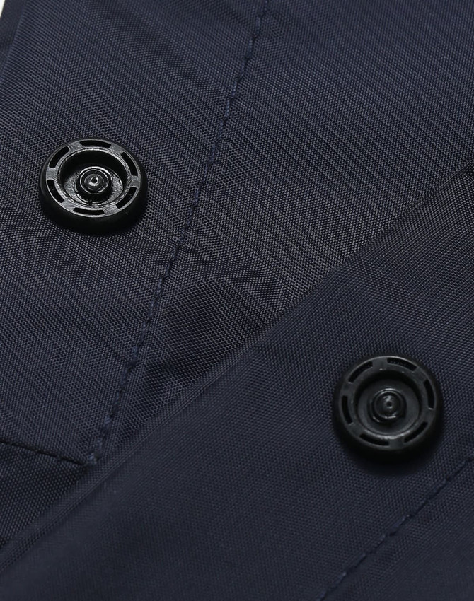Close-up of navy nylon fabric featuring black buttons, part of waterproof rain pants.
