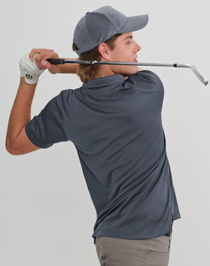 A model swings a golf club while wearing a grey sustainable jacquard knit short-sleeve polo shirt and a cap.