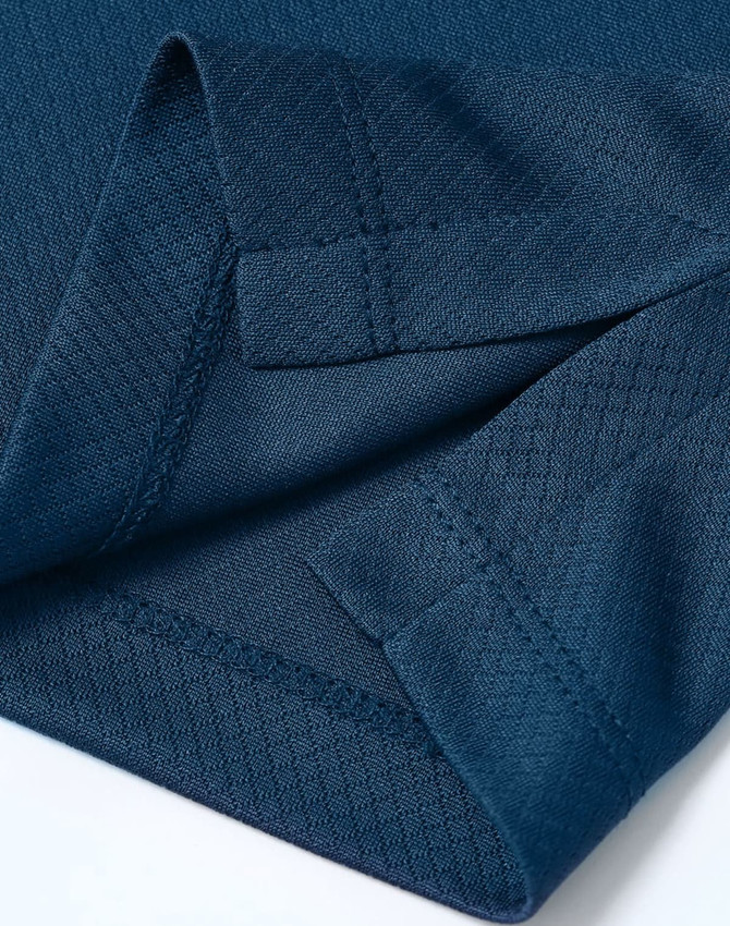 A close-up of a deep navy Jacquard knit fabric with detailed stitching and an edge finish. Features a branding logo.
