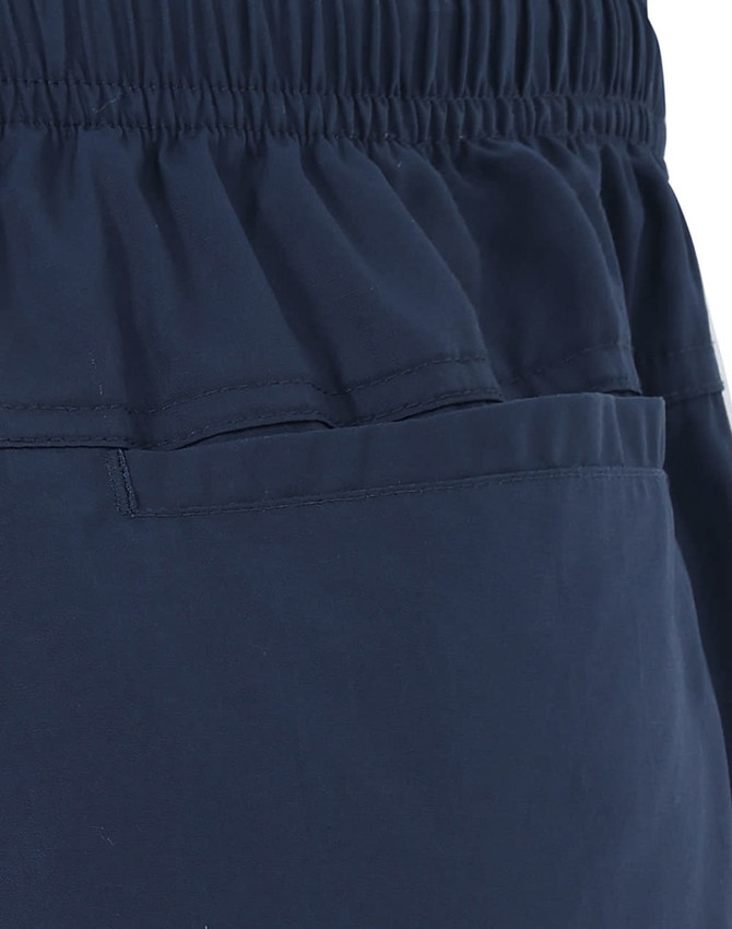 Unisex mercerised cotton shorts in navy, featuring an elastic waistband and a pocket design.