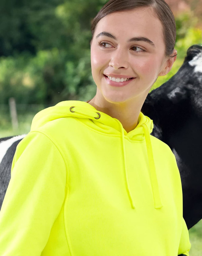 A bright yellow water-resistant fleece hoodie with a hood, featuring a logo, shown against a natural background.
