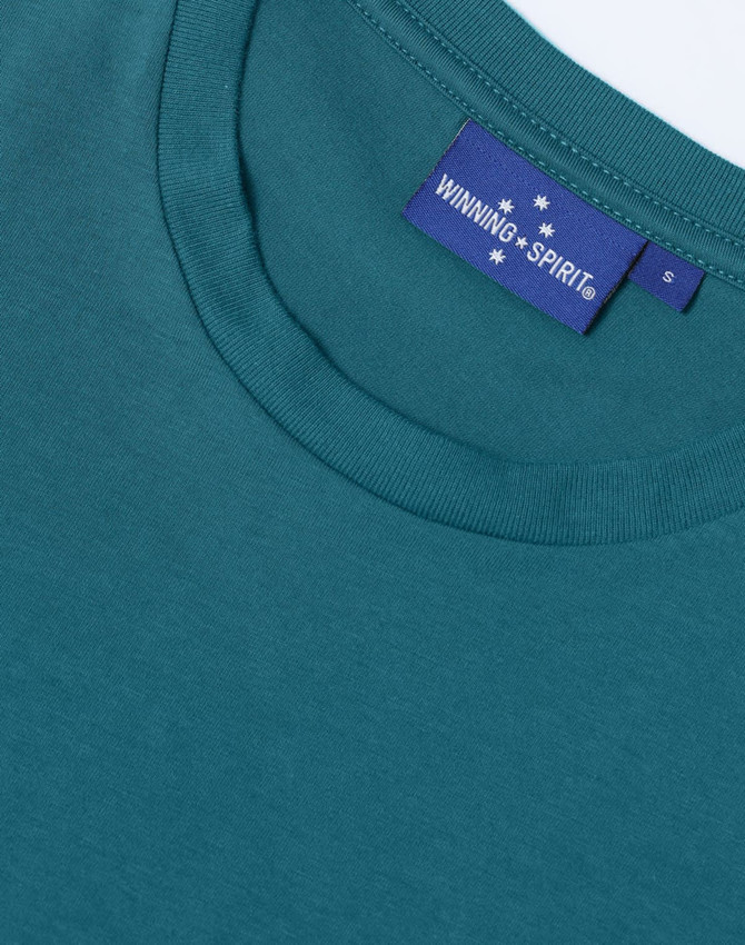 A close-up of a teal men's premium cotton t-shirt featuring a crew neckline and a branded label.