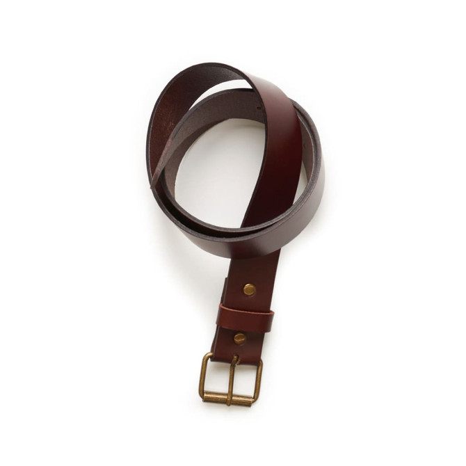 A brown leather belt with a brass buckle, neatly coiled on a white background.