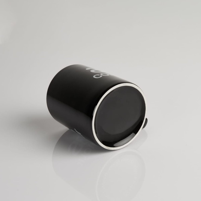 A black coffee mug with a glossy finish and a logo. The mug has a sleek, modern design.