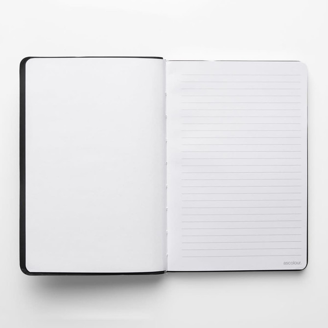 A black ASC Notebook with blank pages on the left and lined pages on the right.