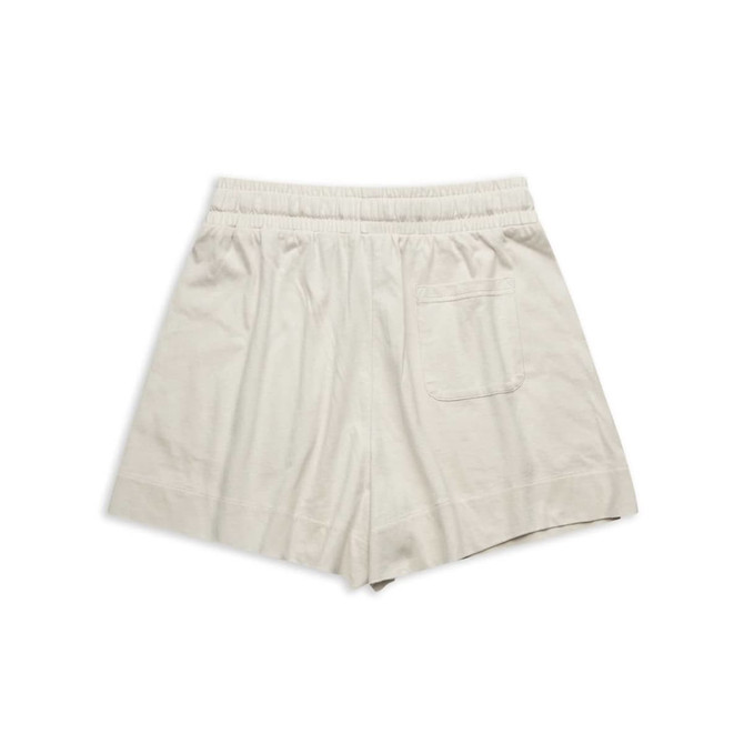 Soft beige sports shorts featuring an elastic waistband and a single back pocket. Includes a logo.