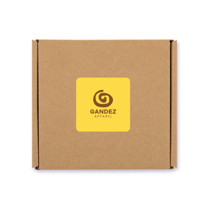 A brown cardboard box with a yellow label featuring a logo and the brand name "Gandez Apparel."