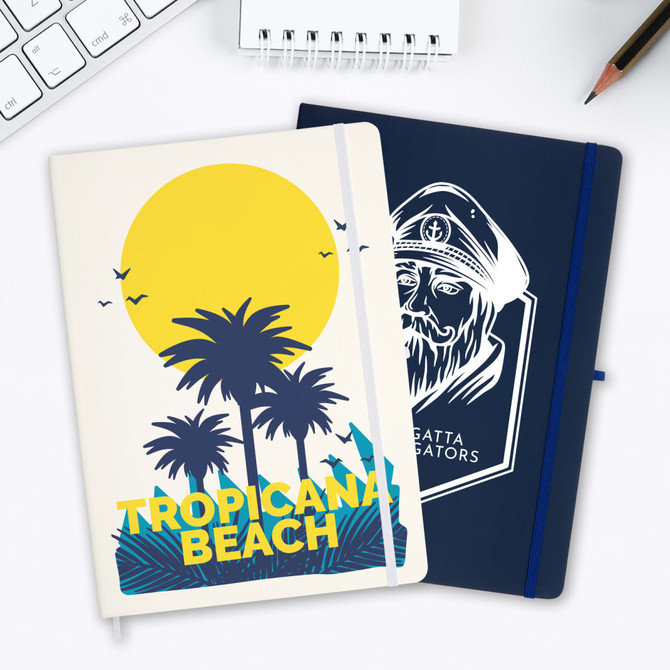 A duo of Capella A4 notebooks featuring a tropical beach design and a navy cover with a logo.