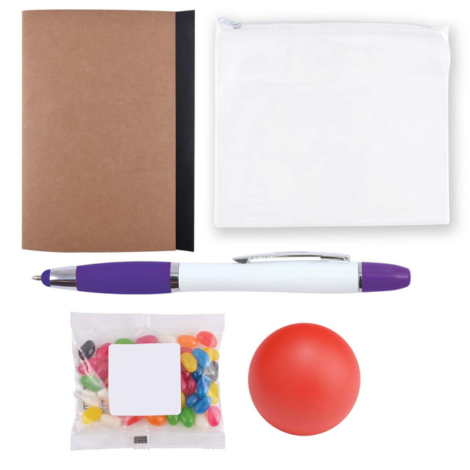 A notebook, a clear zip pouch, a purple and white pen, a bag of colorful jelly beans, and a red stress ball.