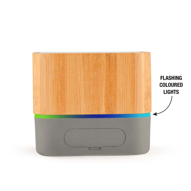 A bamboo Bluetooth speaker with a grey base, featuring a strip of flashing colored lights at the bottom.