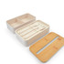 A beige eco lunch box with a bamboo lid, featuring utensils inside and a divided compartment for food storage.