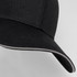 A black six-panel cap with a curved brim and contrasting trim, featuring a logo on the front.