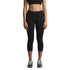 A pair of black mid-length leggings, featuring a fitted design and a subtle logo, worn with athletic shoes.