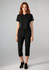 A women's black short sleeve polo shirt displayed with matching black pants, featuring a logo on the polo.