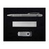 A silver pen, a sleek metal bar, and a silver USB drive arranged on a black background.