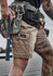 Men's essential stretch cargo shorts in light brown, featuring multiple pockets and a branding label.
