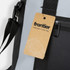 A grey cooler bag with black accents, featuring a tag and a strap attachment. Includes a logo.