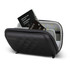A black travel pouch with a zipped closure, featuring a passport and other documents inside. It has a logo.