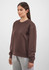A brown crew sweatshirt with long sleeves, featured on a model against a light background.