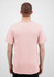 A men's short sleeve tee in a soft pink colour, featuring a plain design and a logo on the back.