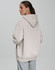 A unisex premium fleece oversized hoodie in a light beige colour, featuring a hood and a relaxed fit.