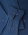 A navy blue long-sleeve cotton blend shirt with buttons and a folded sleeve detail. It features a logo.
