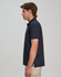A navy men's ultrafine cotton pique polo shirt displayed on a model in profile view. Features a logo.