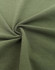 A close-up of a green fabric, showcasing its texture and softness, with a circular twist pattern.