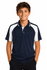 A navy and white polo shirt featuring a logo, worn by a smiling boy with hands in pockets.