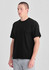 A black men's box tee displayed on a model, featuring a relaxed fit and short sleeves.