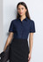 A navy women's short sleeve shirt with a collared neckline and buttons, paired with a black skirt.