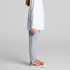 Grey track pants for kids, featuring an elasticated waistband and a relaxed fit, paired with stylish shoes.