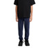 Navy track pants worn by a child, paired with a black T-shirt and black sneakers. The pants have a logo.