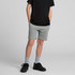 Youth stadium shorts in grey, featuring a comfortable fit and side pockets, worn with a black shirt and sneakers.