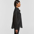 A black linen button-up shirt displayed on a model from a side view, featuring a collar and long sleeves.