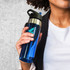 A drink bottle in blue and black with a silver rim and a spout, featuring a logo on the side.